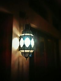 Low angle view of illuminated light bulbs hanging from ceiling