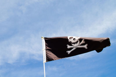 Low angle view of flag against sky