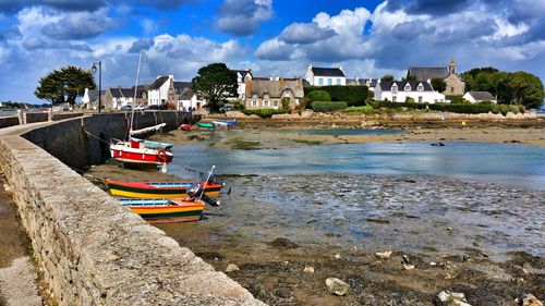 Boats moored at beach against sky