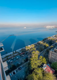 High angle view of sea and buildings against sky