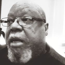 Close-up portrait of man wearing eyeglasses