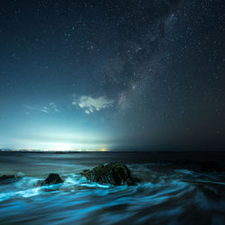 Scenic view of sea against sky at night