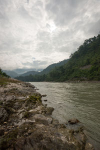 Scenic view of mountains against cloudy sky