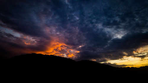 Scenic view of silhouette mountains against sky during sunset