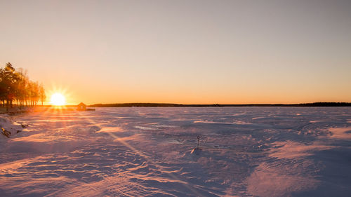 Scenic view of sea against clear sky during sunset