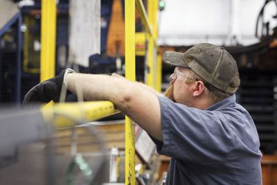 Side view of worker in steel industry factory