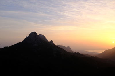 Scenic view of silhouette mountains against sky during sunset