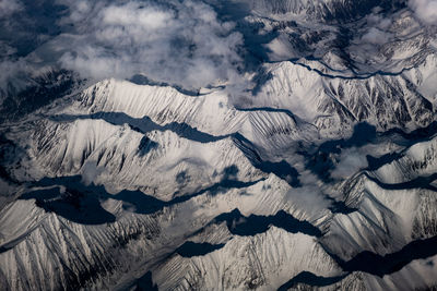 Aerial view of snowcapped mountains against sky