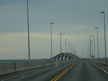 Empty high way against sky at dusk