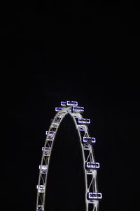 Low angle view of illuminated ferris wheel at night