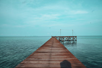 Pier over sea against sky