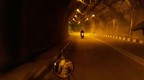 Man in illuminated tunnel