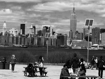 View of cityscape against cloudy sky