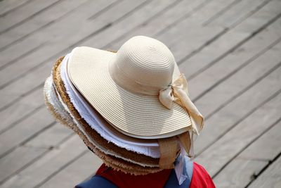 Rear view of street seller wearing hats 