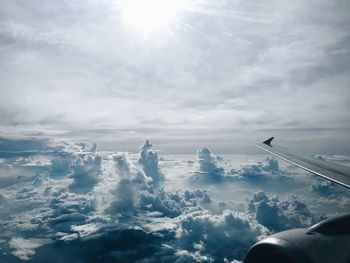 Airplane flying over cloudscape against sky