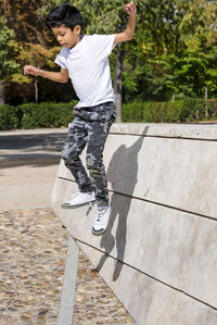 Young boy jumping while having fun in a park.