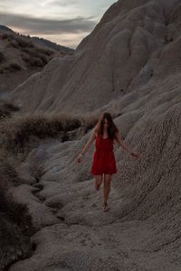 Full length of woman standing on rock formation