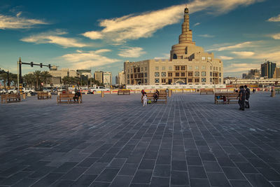 People on street with buildings in background