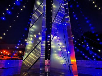 Low angle view of illuminated bridge at night