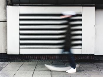 Low section of person walking on tiled floor