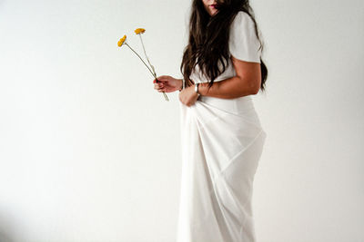 Side view of woman standing against white background