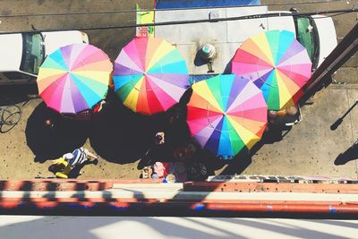 People on multi colored umbrella