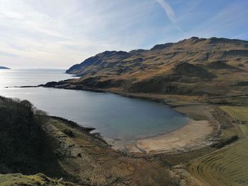 Scenic view of sea and mountains against sky