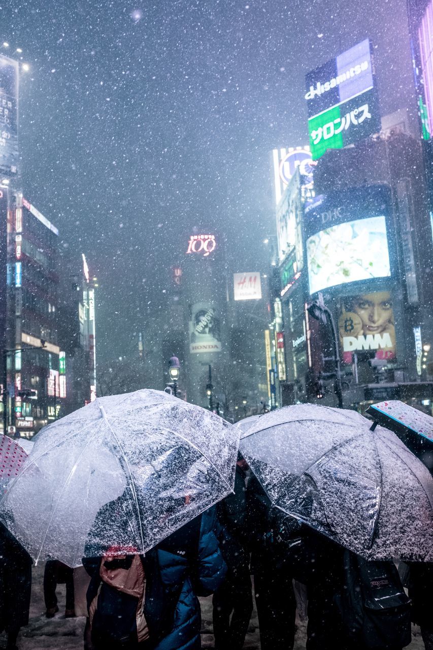 umbrella, rain, weather, wet, rainy season, rainfall, protection, raindrop, city, snowing, below, torrential rain, real people, cold temperature, night, under, lifestyles, holding, outdoors, men, shelter, water, adult, one person, people, adults only, lightning, only men