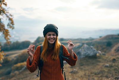 Portrait of smiling young woman standing outdoors