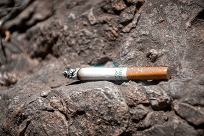 Close-up of cigarette on wood