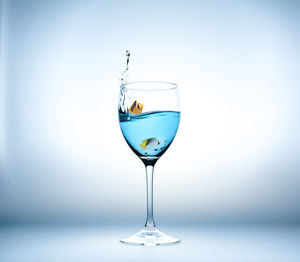 Close-up of wine in glass against white background