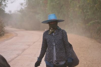 Rear view of woman walking on road