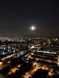 High angle view of illuminated buildings against sky at night