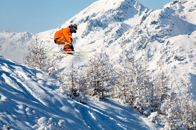 Person skiing on snow covered mountain