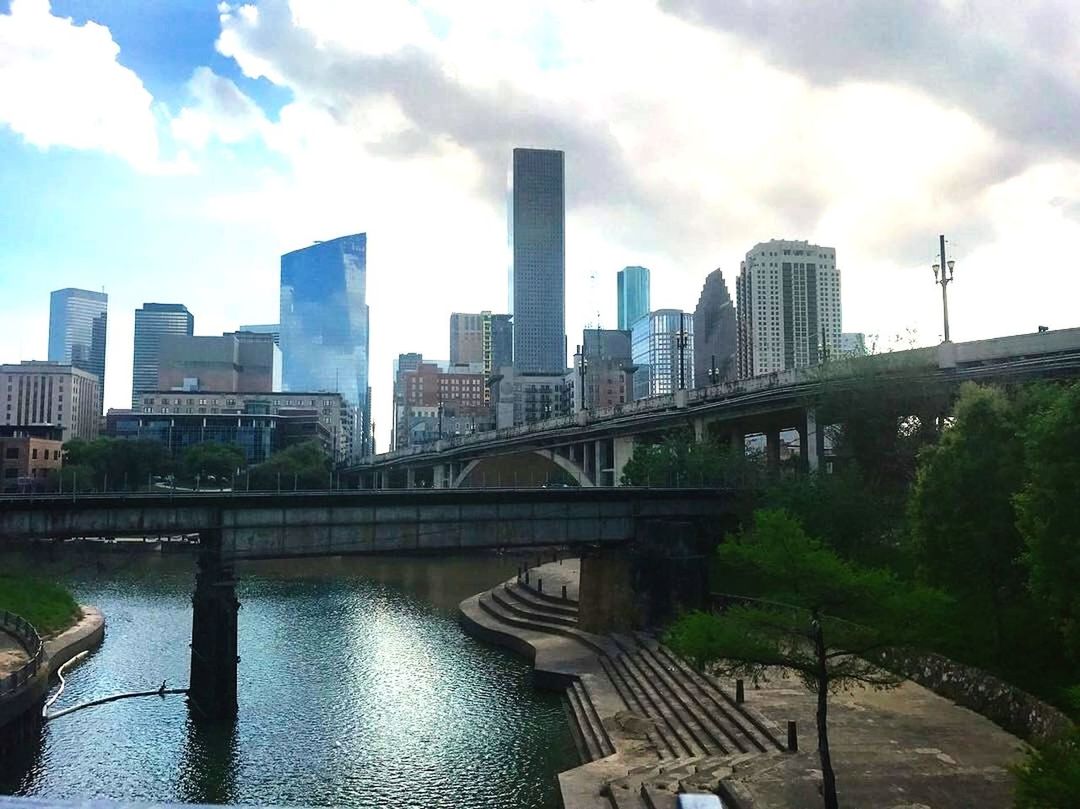 architecture, sky, built structure, skyscraper, building exterior, cloud - sky, river, bridge - man made structure, city, day, connection, outdoors, no people, water, modern, urban skyline, tree, cityscape