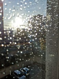 City seen through wet glass window