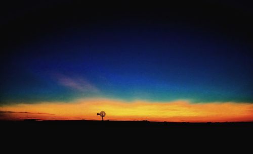 Scenic view of dramatic sky over silhouette land