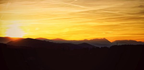 Scenic view of silhouette mountains against sky during sunset