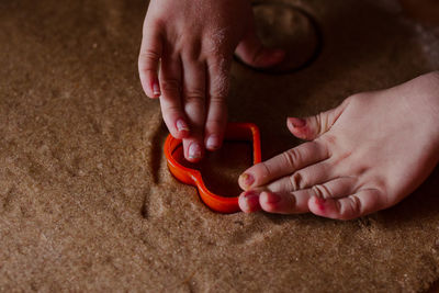 Close-up of baby hands making cookies of hear shape