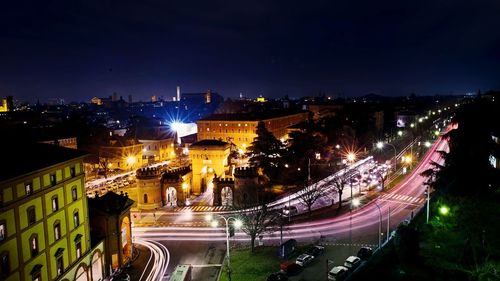 High angle view of light trails by porta saragozza in city at night
