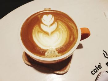 Close-up of cappuccino served on table