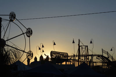 Low angle view of ferris wheel against clear sky