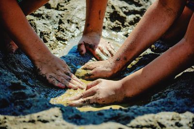 Midsection of man working in water