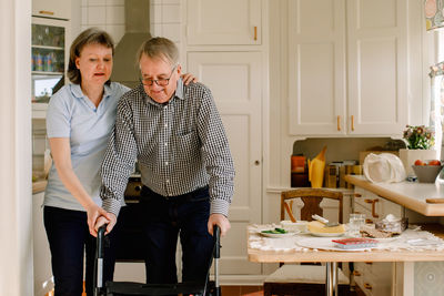 Portrait of friends standing at home