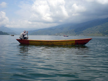 Man rowing boat in lake