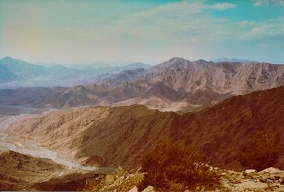 Scenic view of mountains against cloudy sky