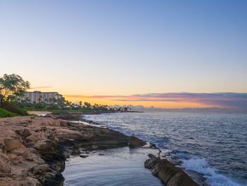 Scenic view of sea against clear sky during sunset