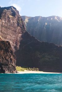 Scenic view of sea and mountains against sky