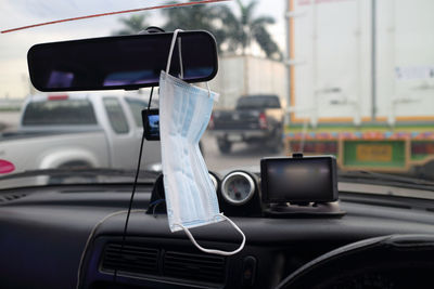 Mask hanging on mirror in car