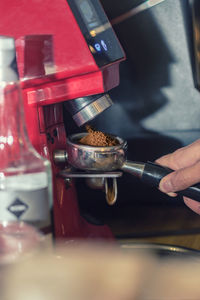 Close-up of hand holding coffee cup